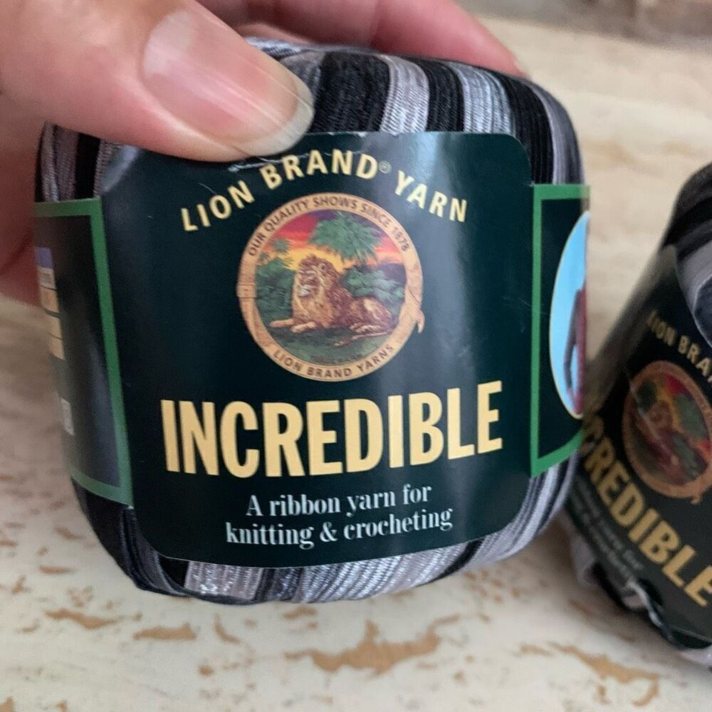 Lion brand incredible ribbon yarn in accent on black